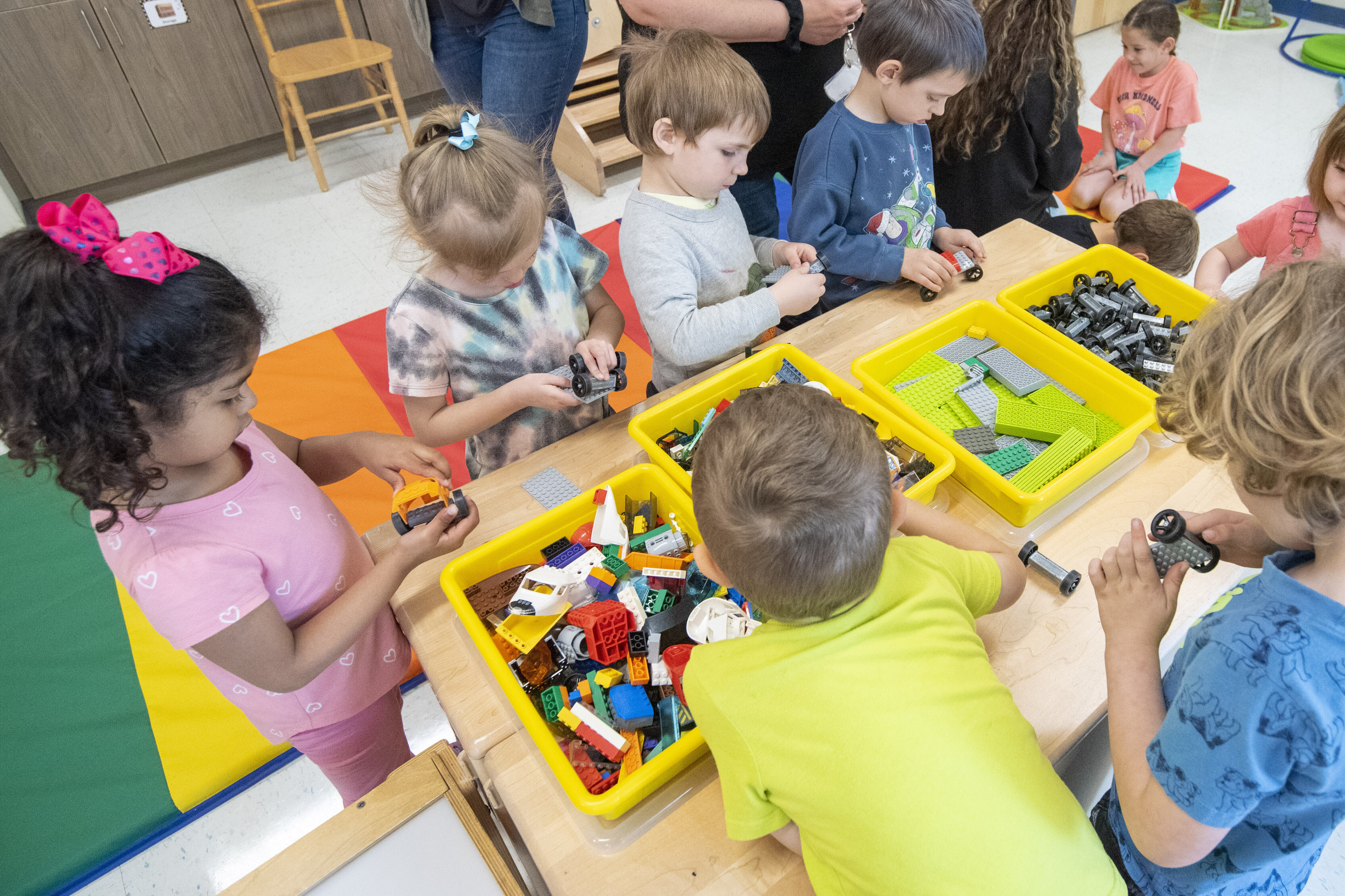 Children at a table playing with legos