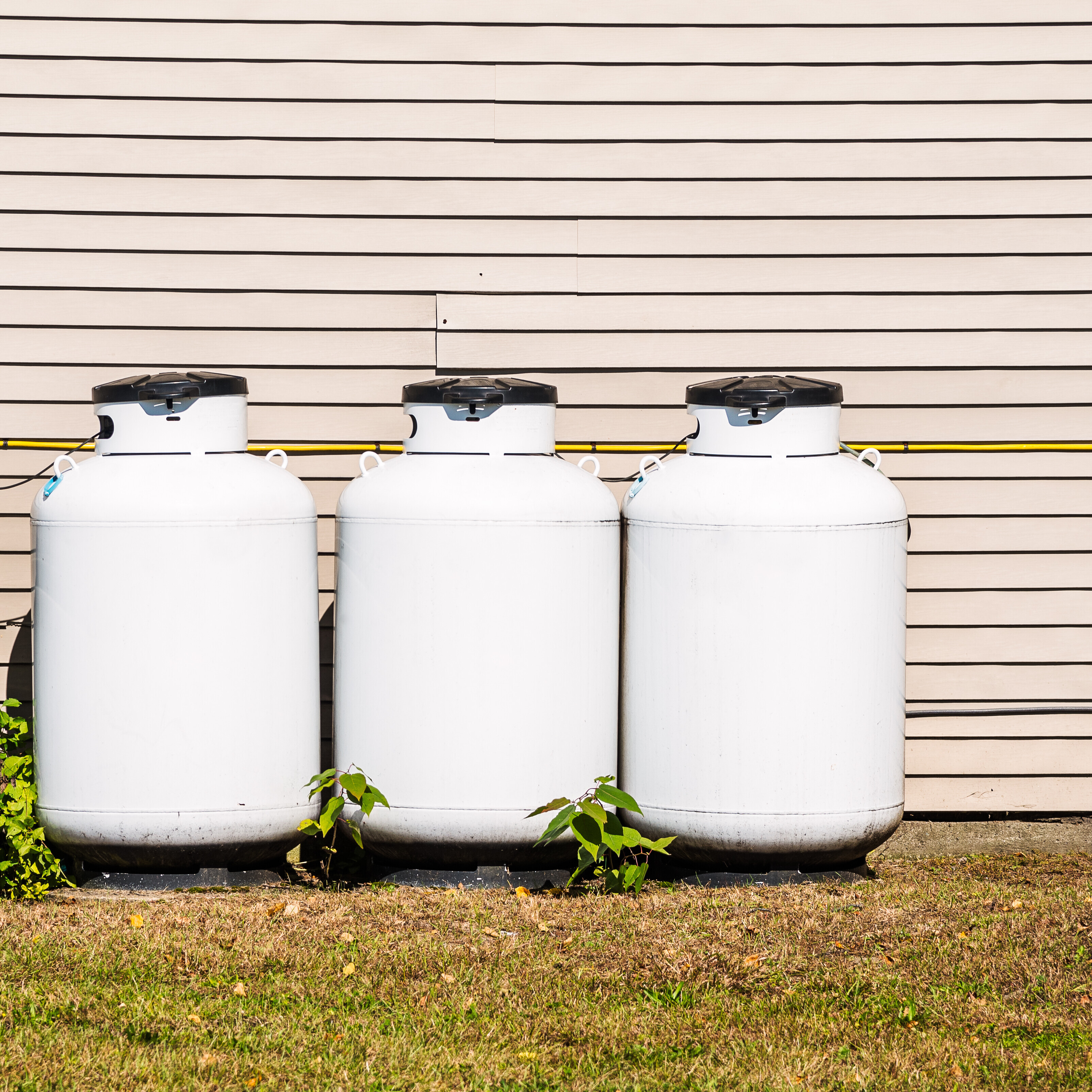 Row of propane tanks along the outside of a building