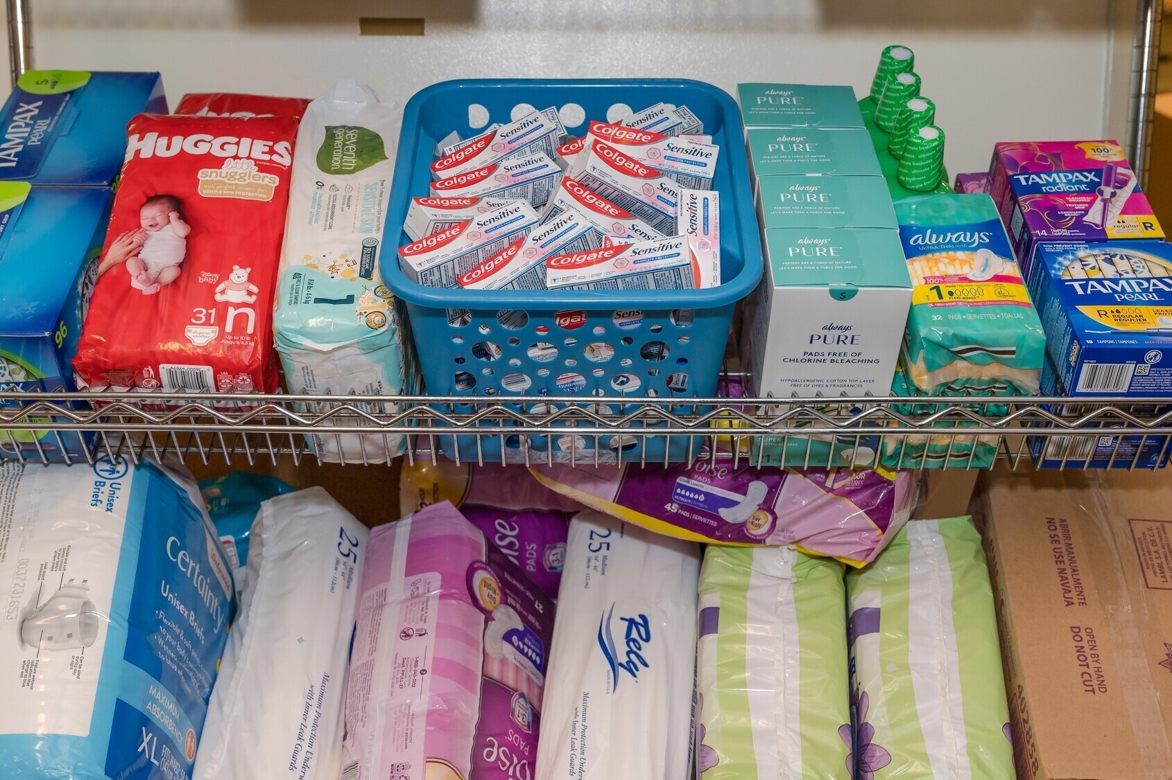 Shelf displaying hygienic items, diapers, and toothpaste