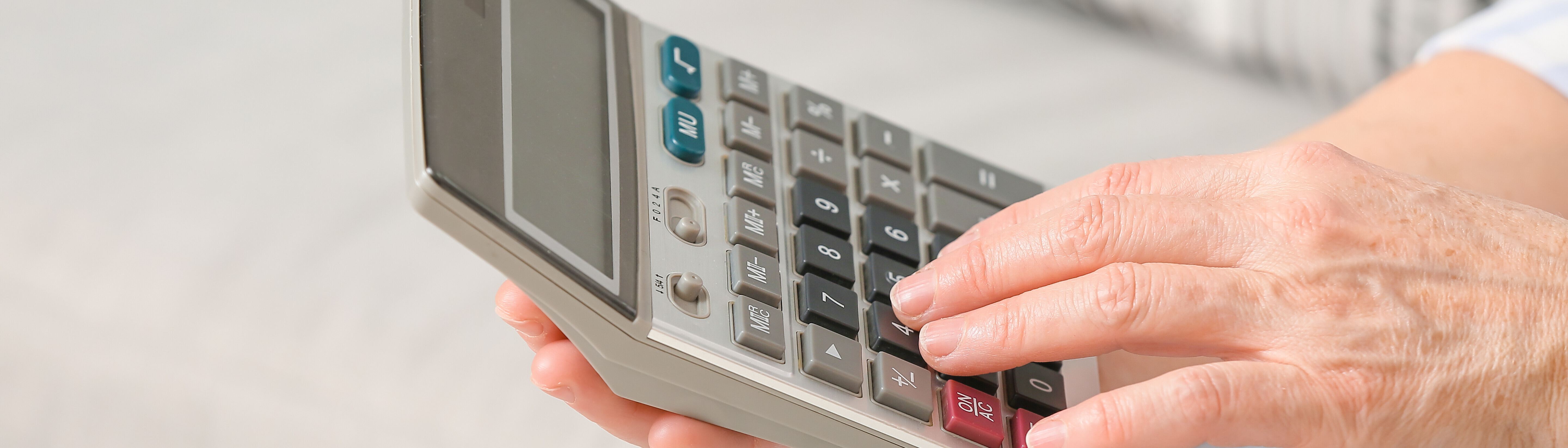 A hand using a calculator