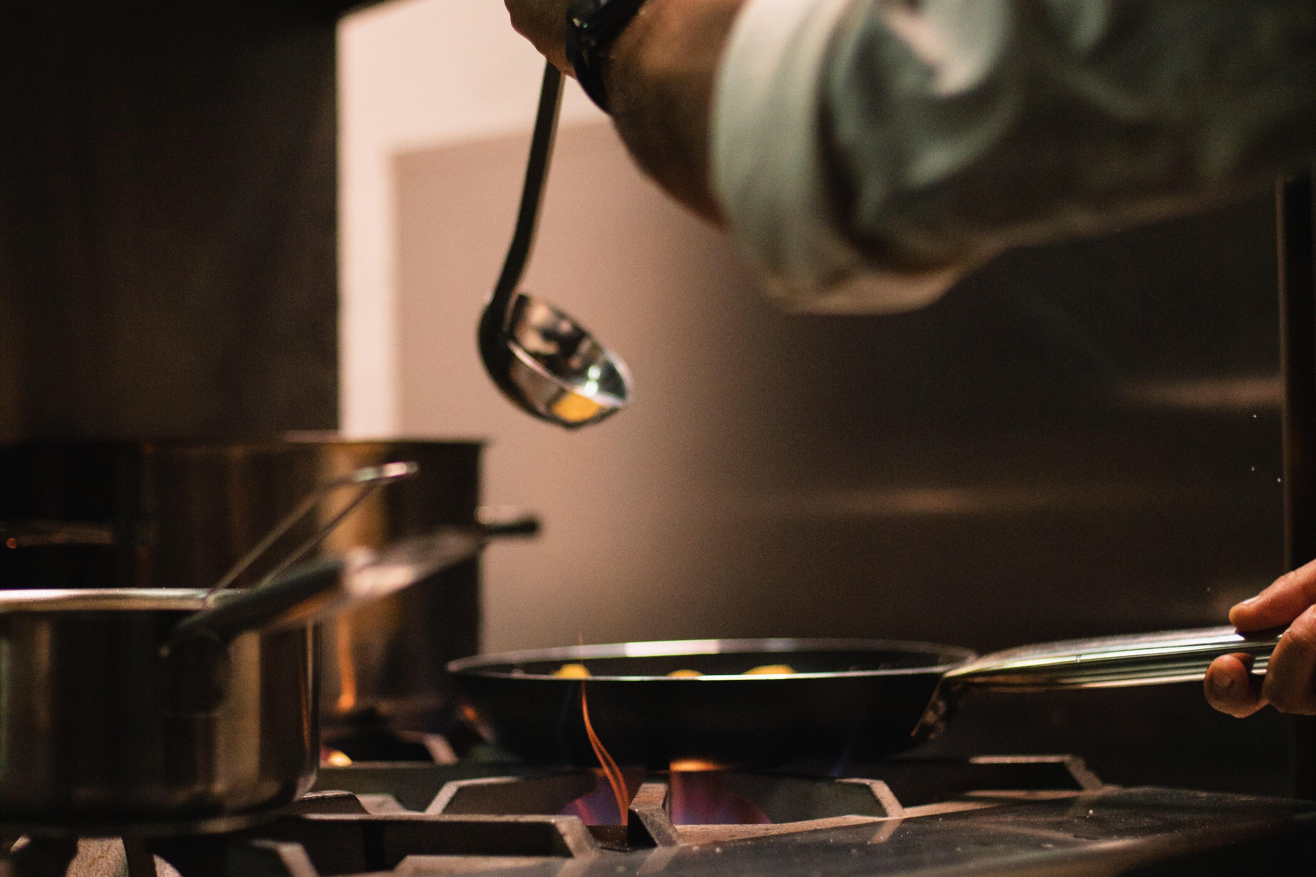Image of ladle being held over a pan  