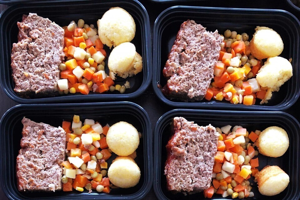 Image of a meatloaf slice, diced veggies and whole potatoes in a containers