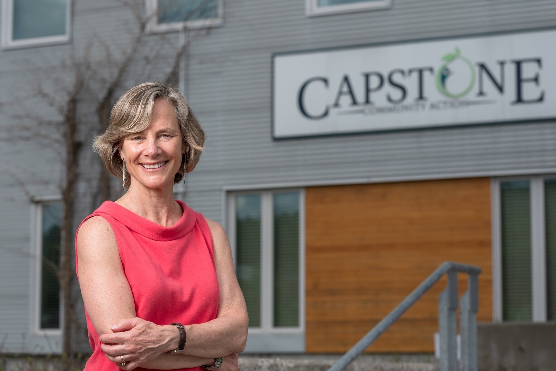 Sue Minter poses in front of Capstone's Gable Place office in Barre.